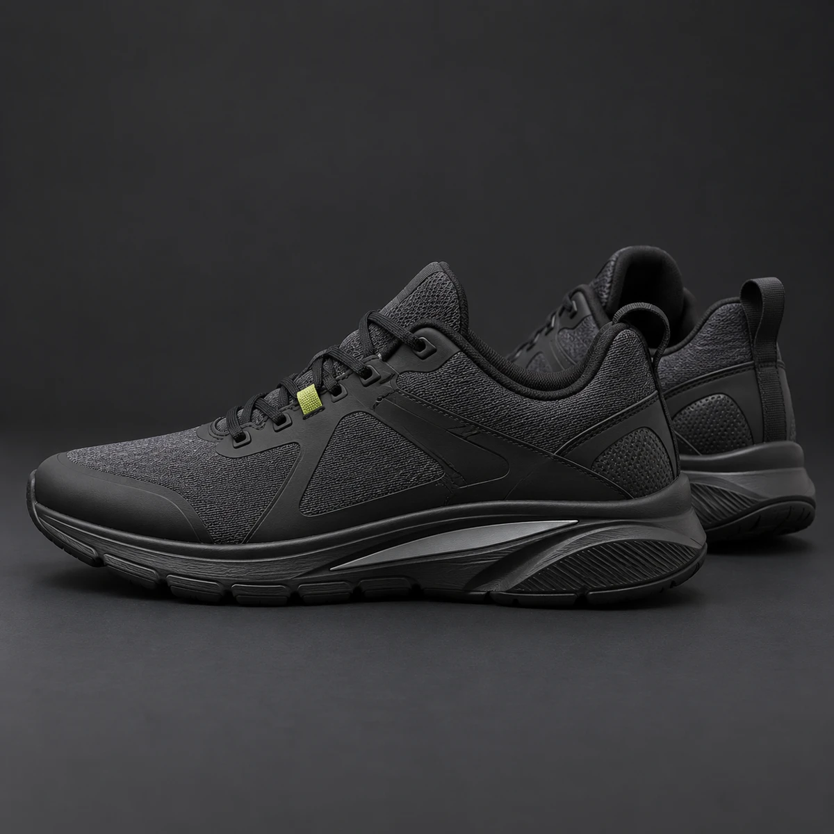 Charcoal trainers with sculpted black soles and reflective inserts